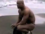 Asian bodybuilder barely covered at the beach