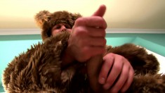 Muscled furry takes off his bear suit to fist-pump his hard cock