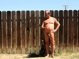 A daddy parading around naked in his backyard.